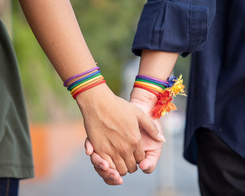 Lesbian couple holding hands. If you need support as an LGBTQ+ individual, reach out to Dr. Ashley Allen