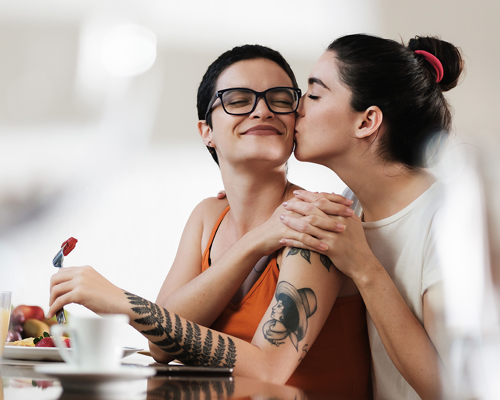 Lesbian couple in the kitchen having breakfast