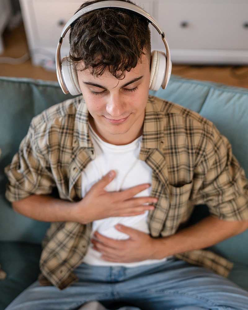 Person with headphones doing a mindfulness meditation online