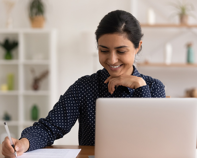 Young woman looking at a laptop doing an online psychological assessment